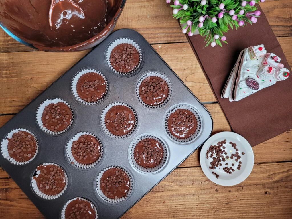 Delicious chocolate cupcakes ready for baking with ingredients.